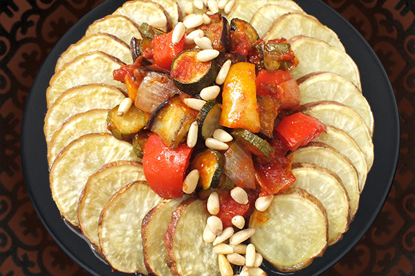 Roast Sweet Potato ring with veg braised in Hot Red Pepper Paste, dressed with Pine nuts