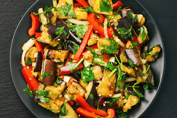 Stir fried aubergine (eggplant) with slices of red pepper, onion and fresh herbs seasoned with Ukuva Fire Spice.