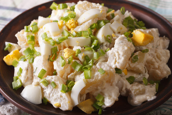 White Potato Salad with chopped spring onions and boiled eggs