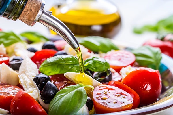 Fresh tomatoes, black olives, torn mozzarella, basil leaves and smoked olive oil 