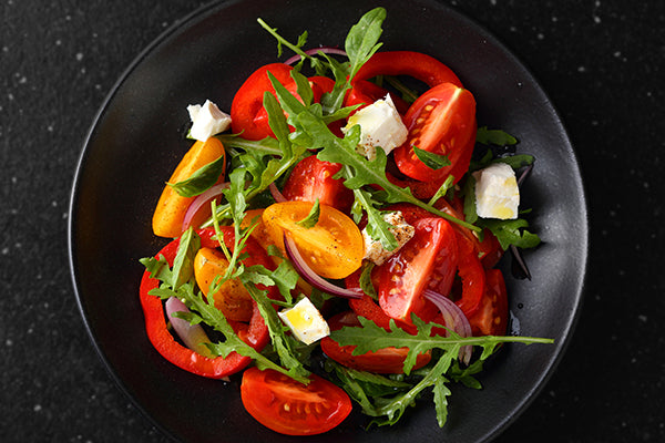 Salad of fresh multi colored tomatoes with wild rocket, creamy Danish Feta, red onion and a dressing made with Pepperdrop Mustard.